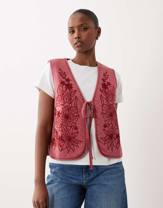 ASOS DESIGN quilted padded waistcoat with floral design in acid wash burgundy