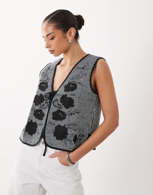 ASOS DESIGN quilted stripe waistcoat with embroidered floral design in black and white