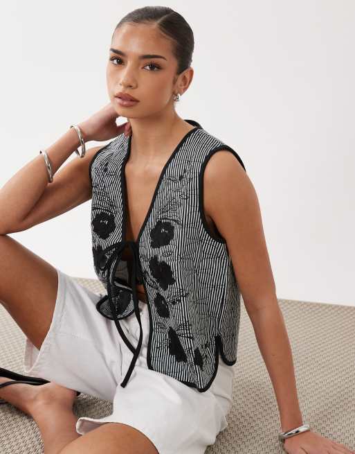 ASOS DESIGN quilted stripe waistcoat with embroidered floral design in black and white